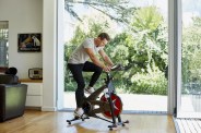 man working out on exercise bike at home