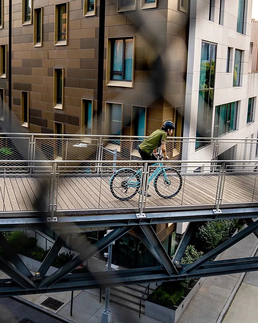 person riding across bridge on electra bicycle company logt go 7d eq e bike