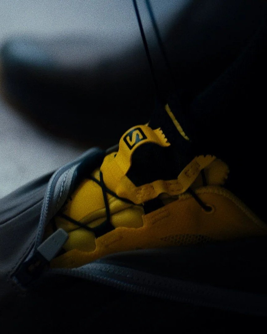 person wearing pas normal studios® x salomon sneakers