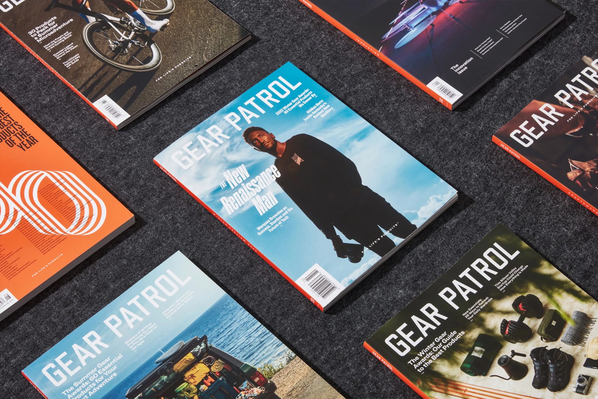 a grid layout of multiple issues of gear patrol magazine on a dark grey background