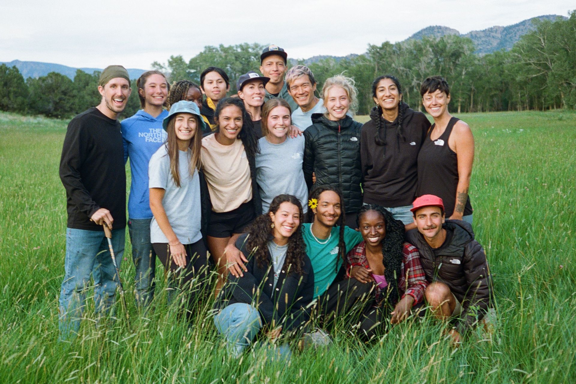 a group of people in a green grassy field