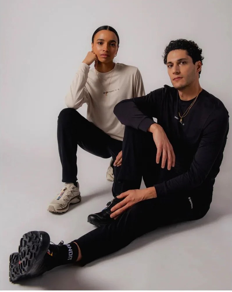 man and woman sitting and posing wearing bandit running spring 2023 gear