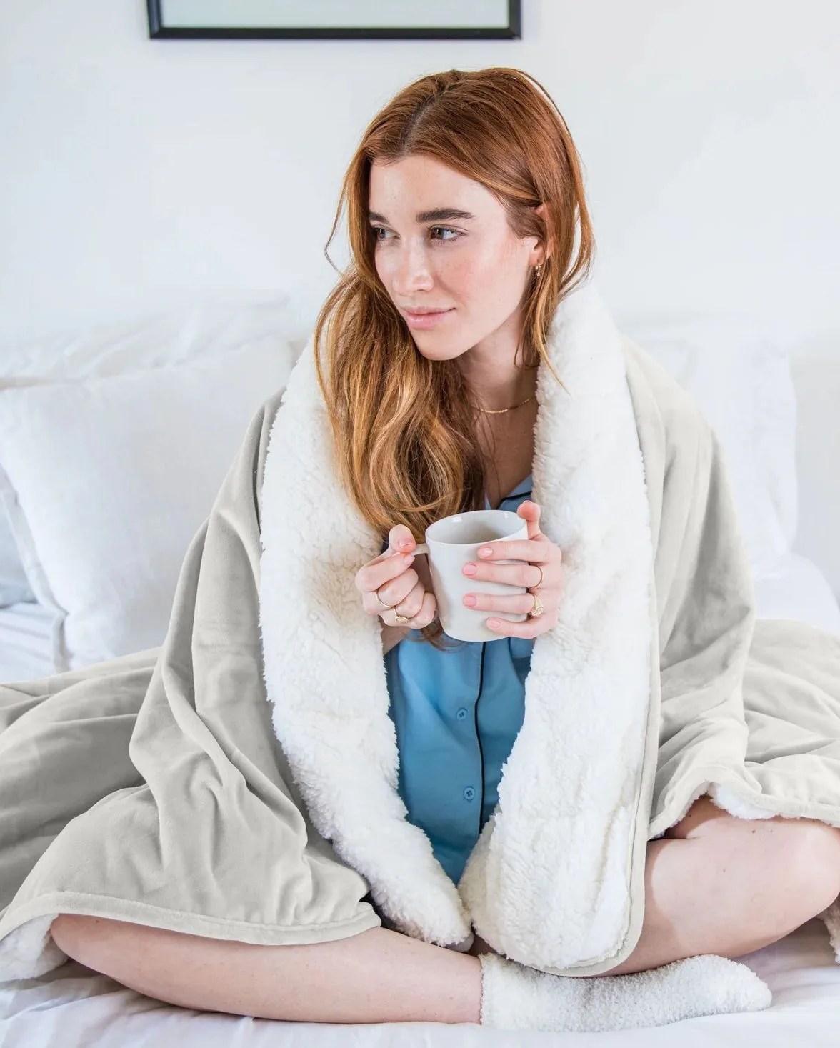 woman using luna double sided sherpa weighted blanket