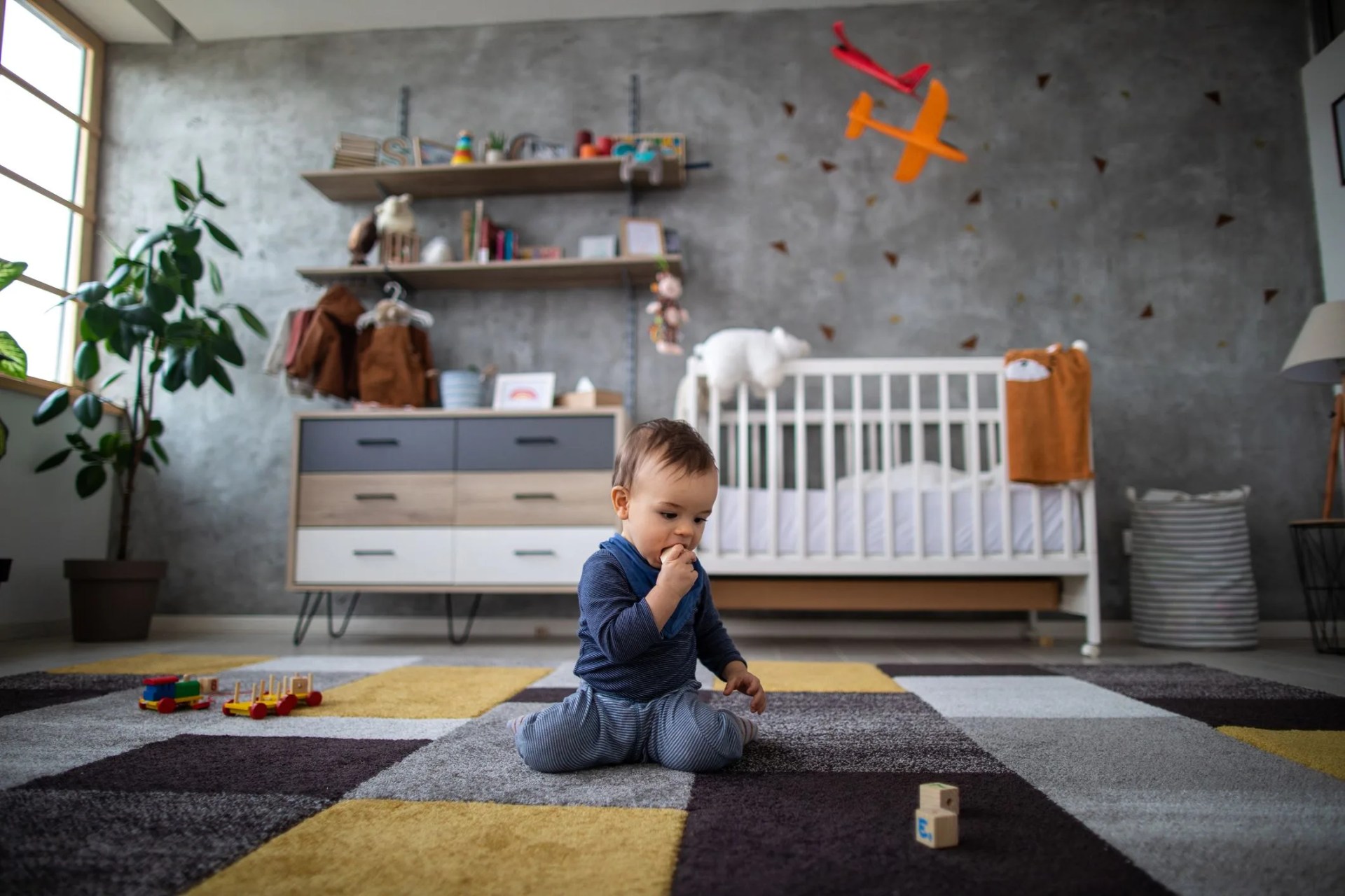 baby boy chewing wooden blocks