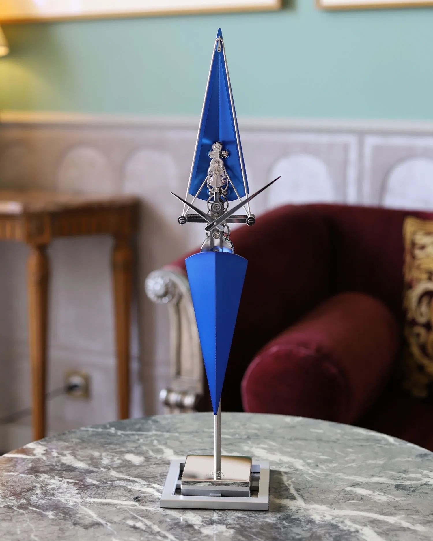 a blue clock on a table