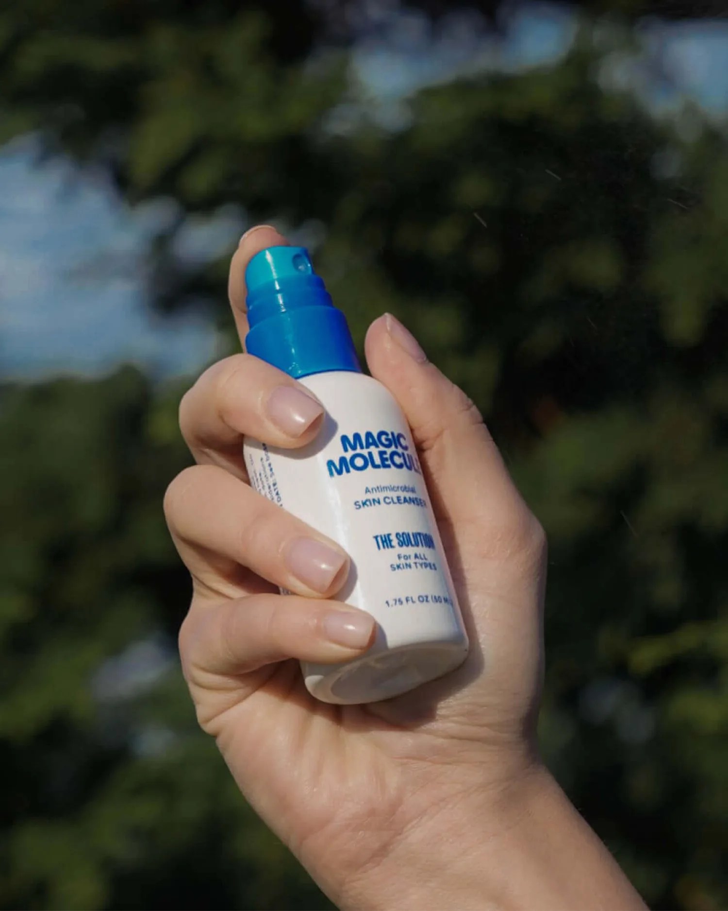 a woman holding a spray bottle