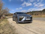 lexus rz parked by the side of a rural road