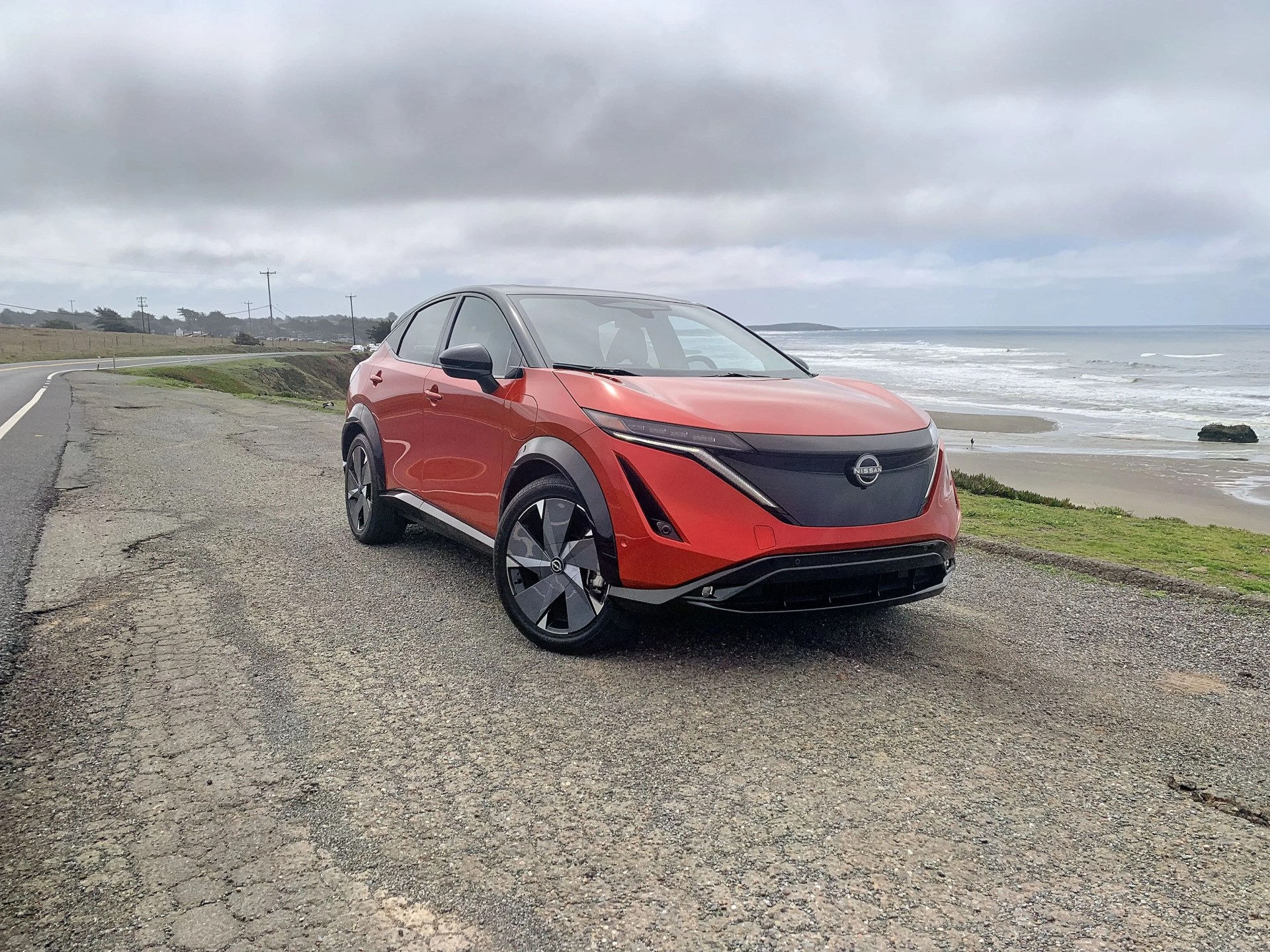 nissan ariya parked by the pacific ocean