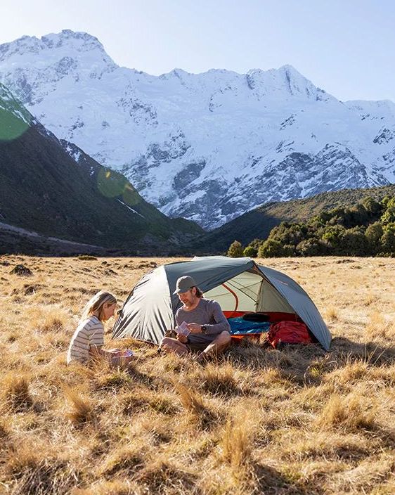 man and woman sitting by ikos lightweight tent