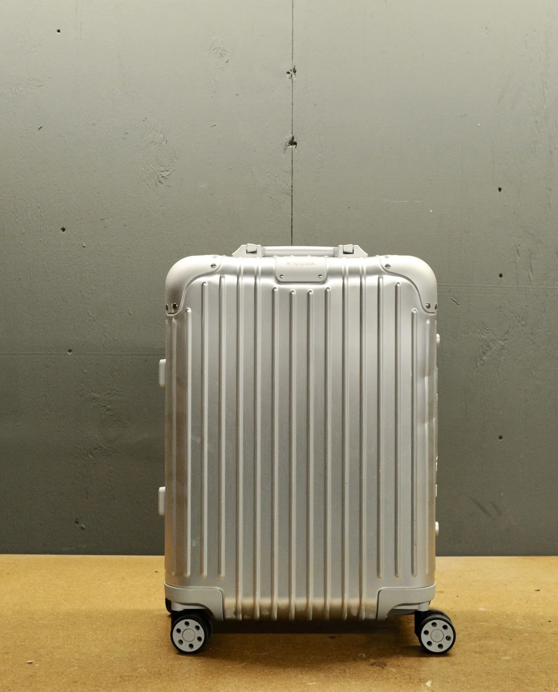 rimowa suitcase on a table