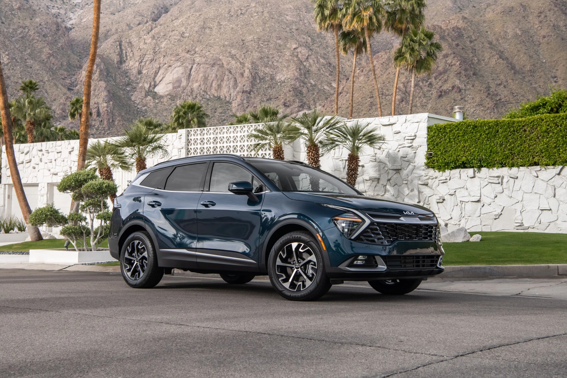 kia sportage hybrid parked next to a palm springs house