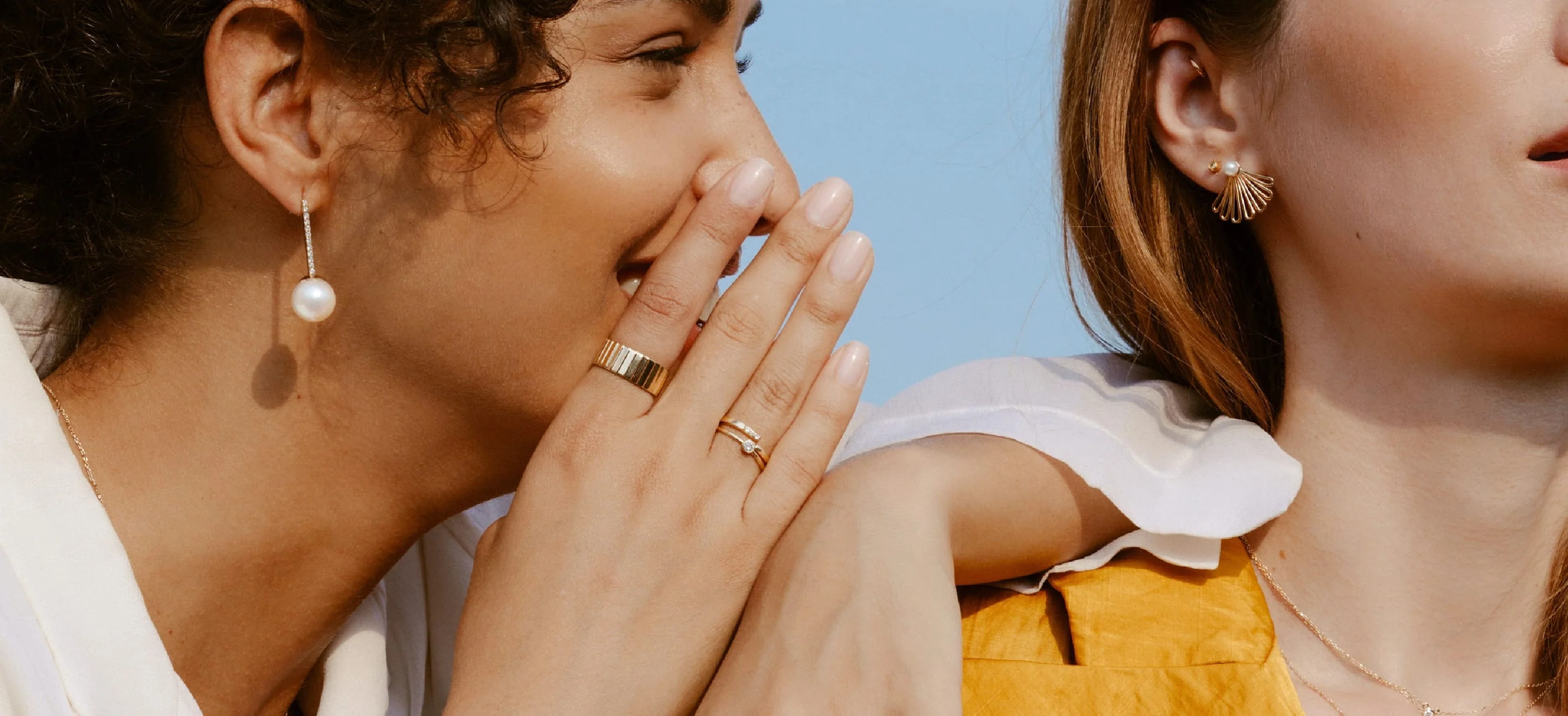 two people wearing aurate jewelry
