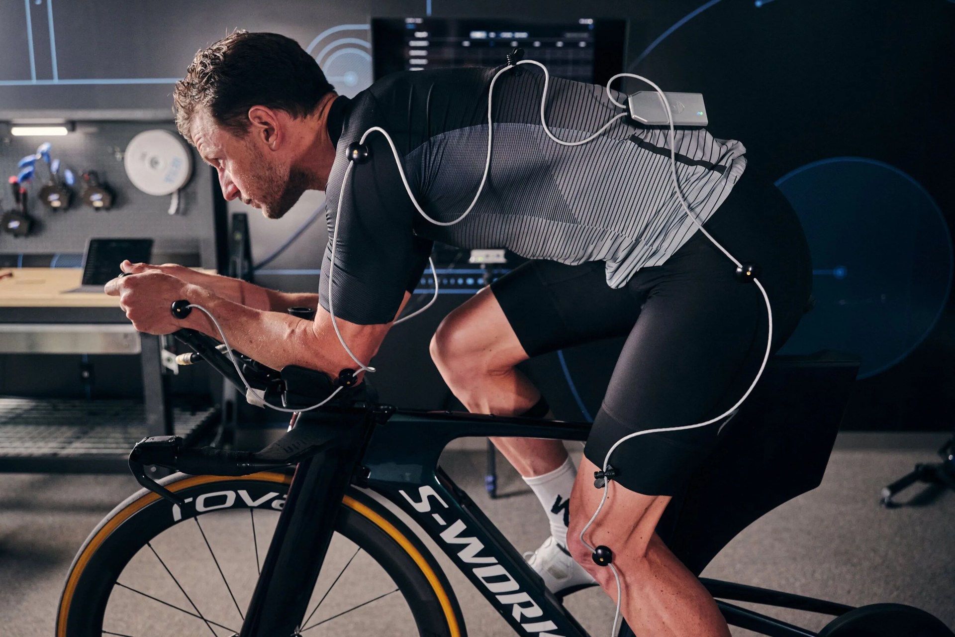 a man on a bike with wires checking his form