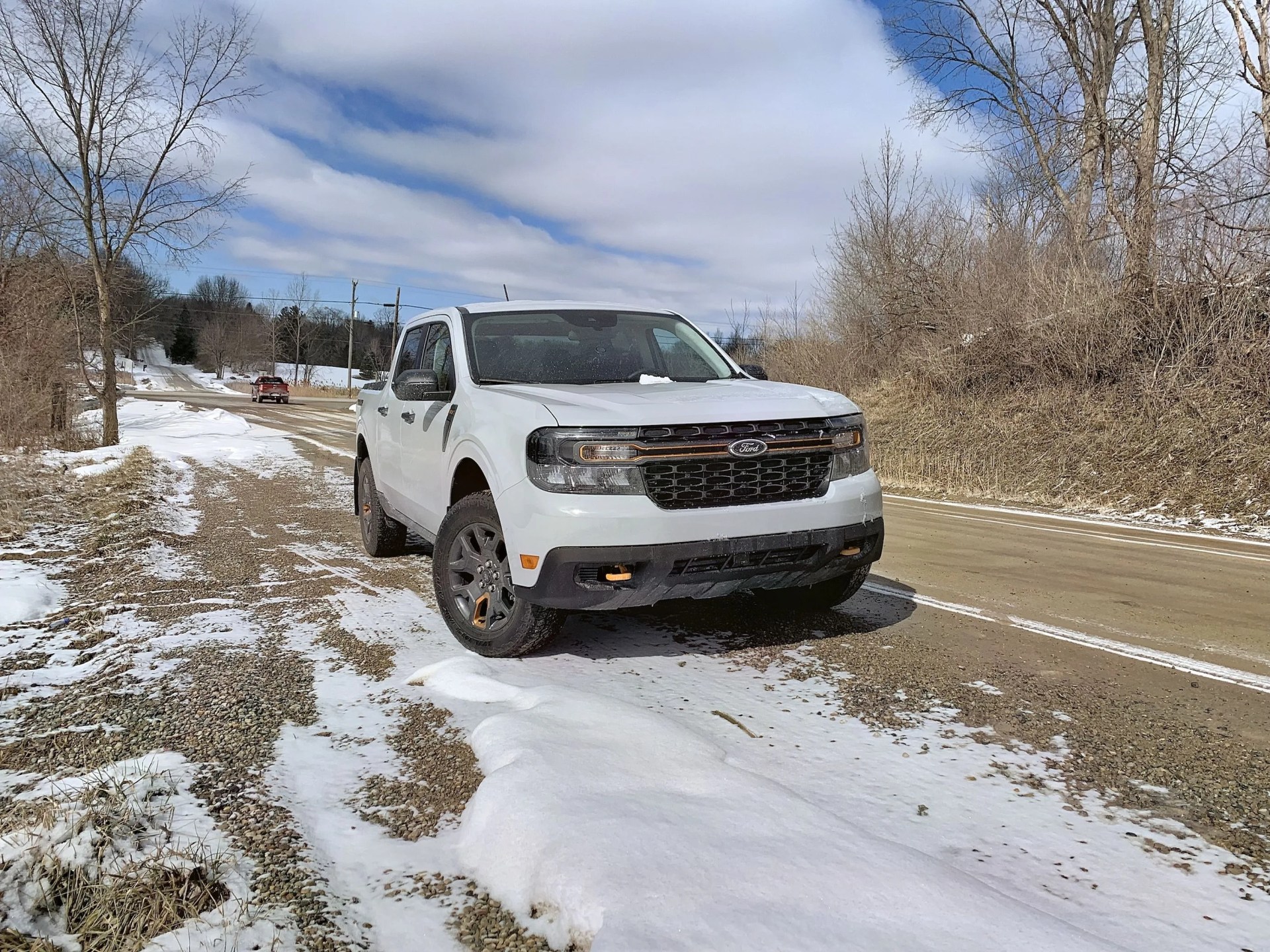 ford maverick parked by a dirt road