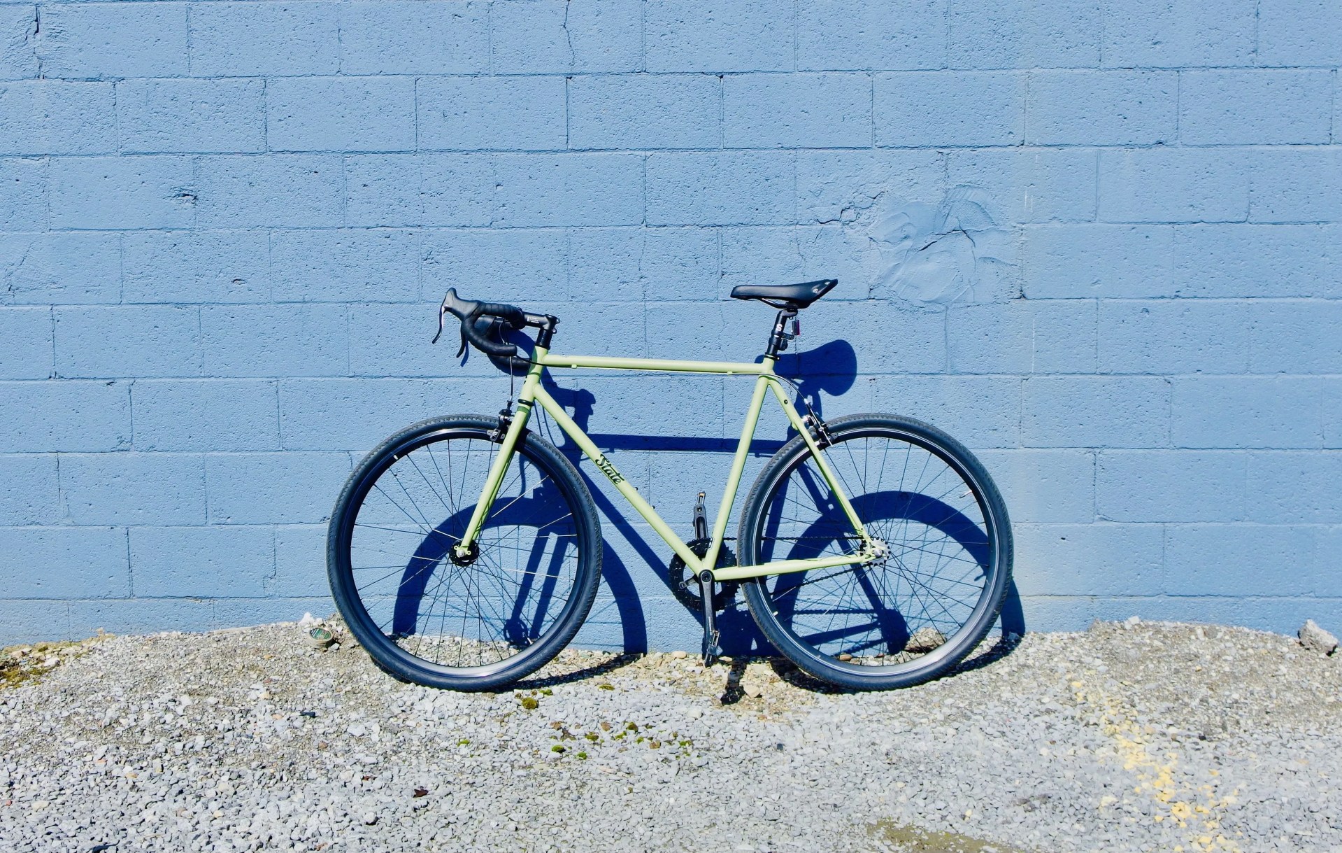 state bike sitting against a blue wall