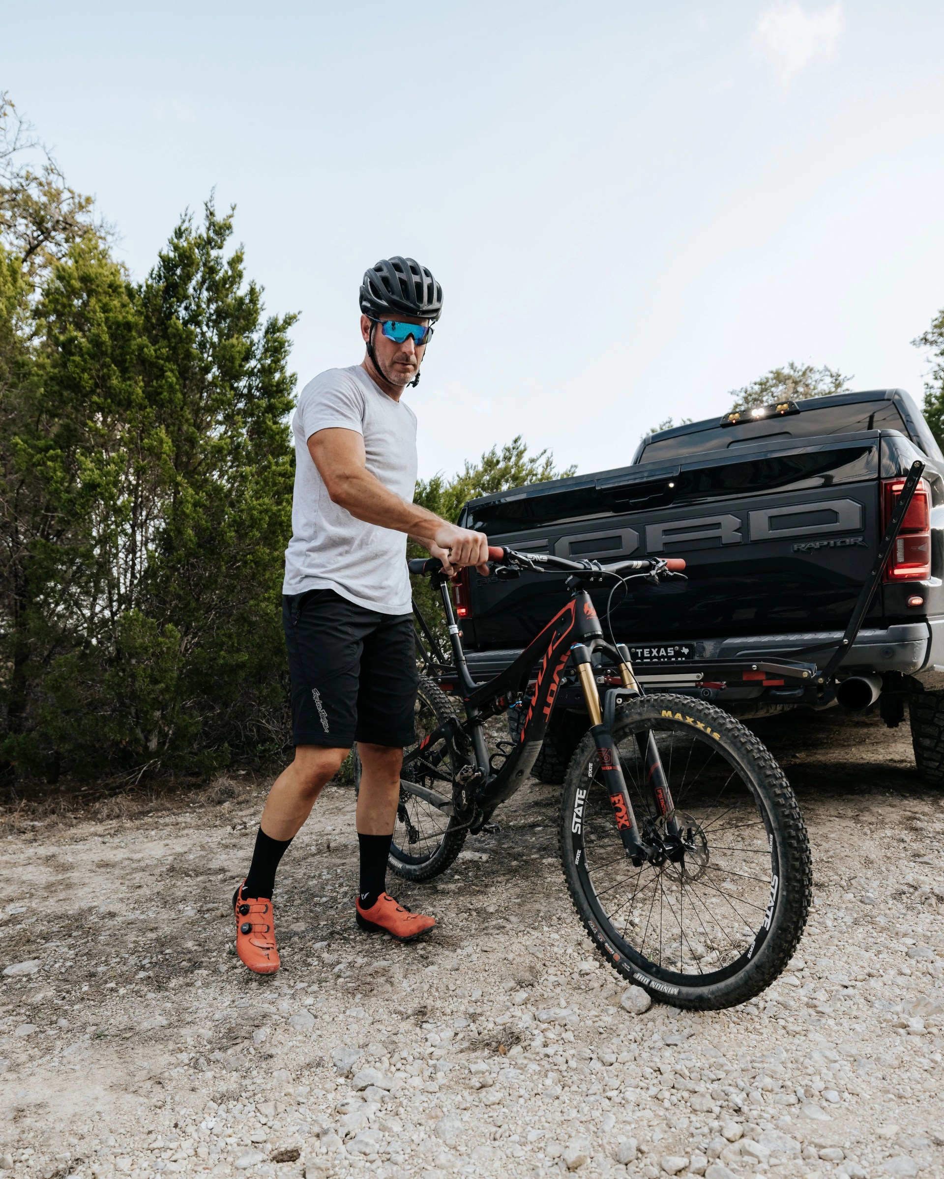 jason standing next to ford truck holding his bike