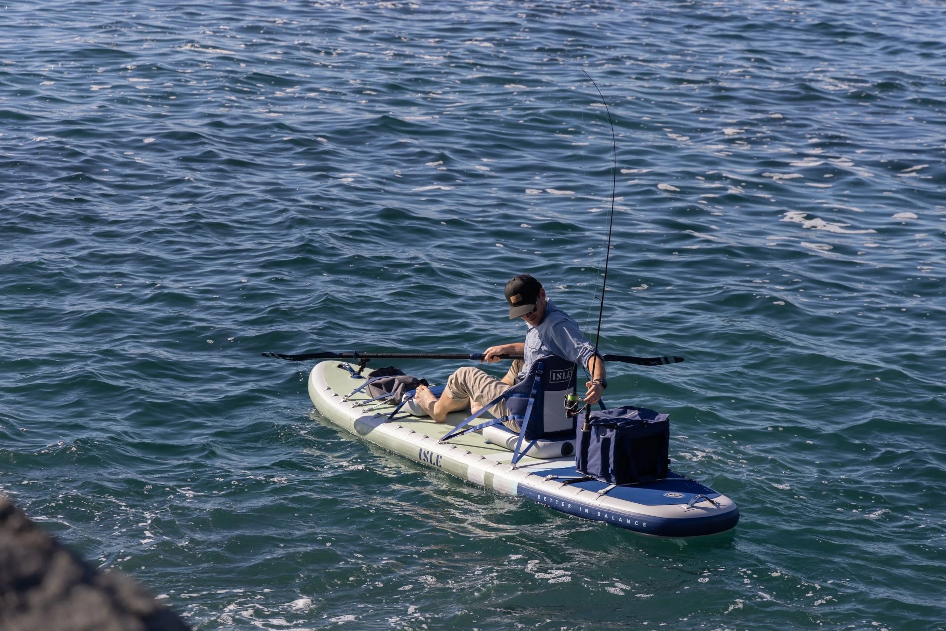 man fishing on paddle board