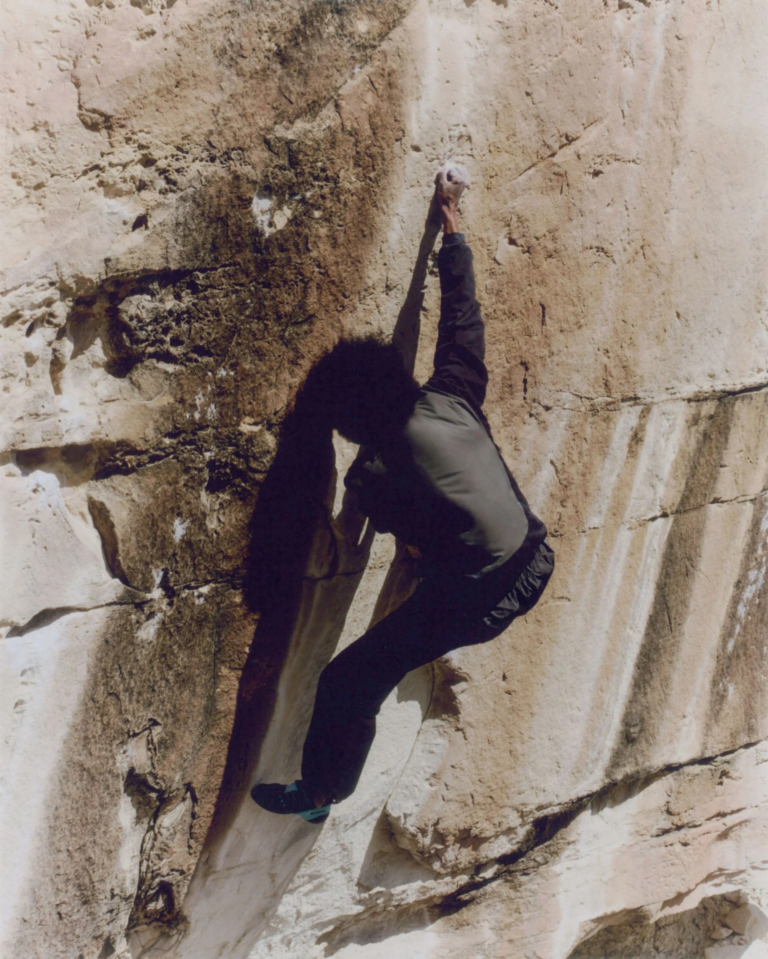 man climbing wall wearing arc'teryx system a gear