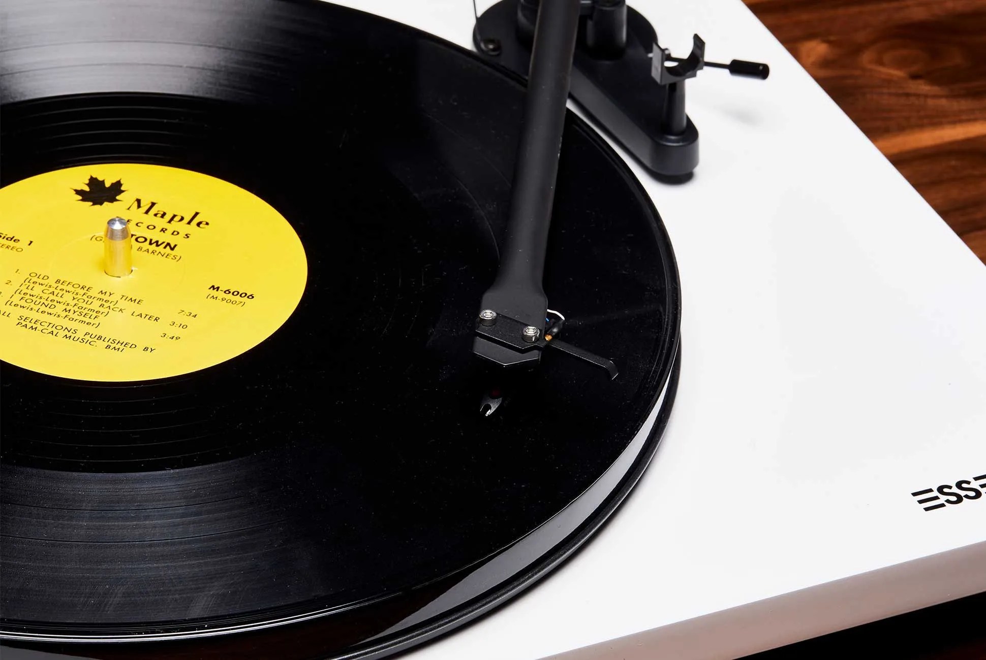 vinyl record spinning on a white turntable