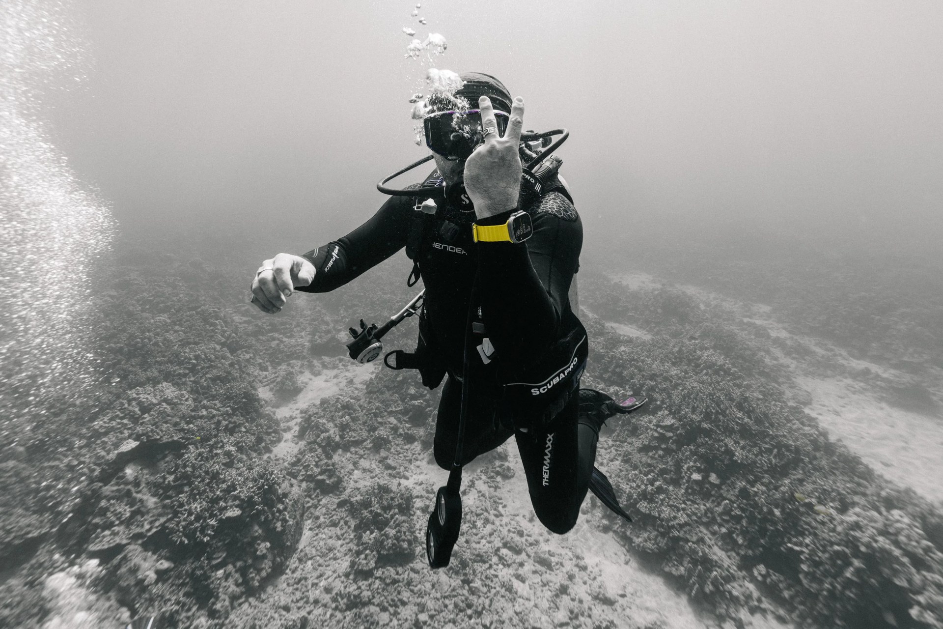 a person scuba diving wearing an apple watch ultra