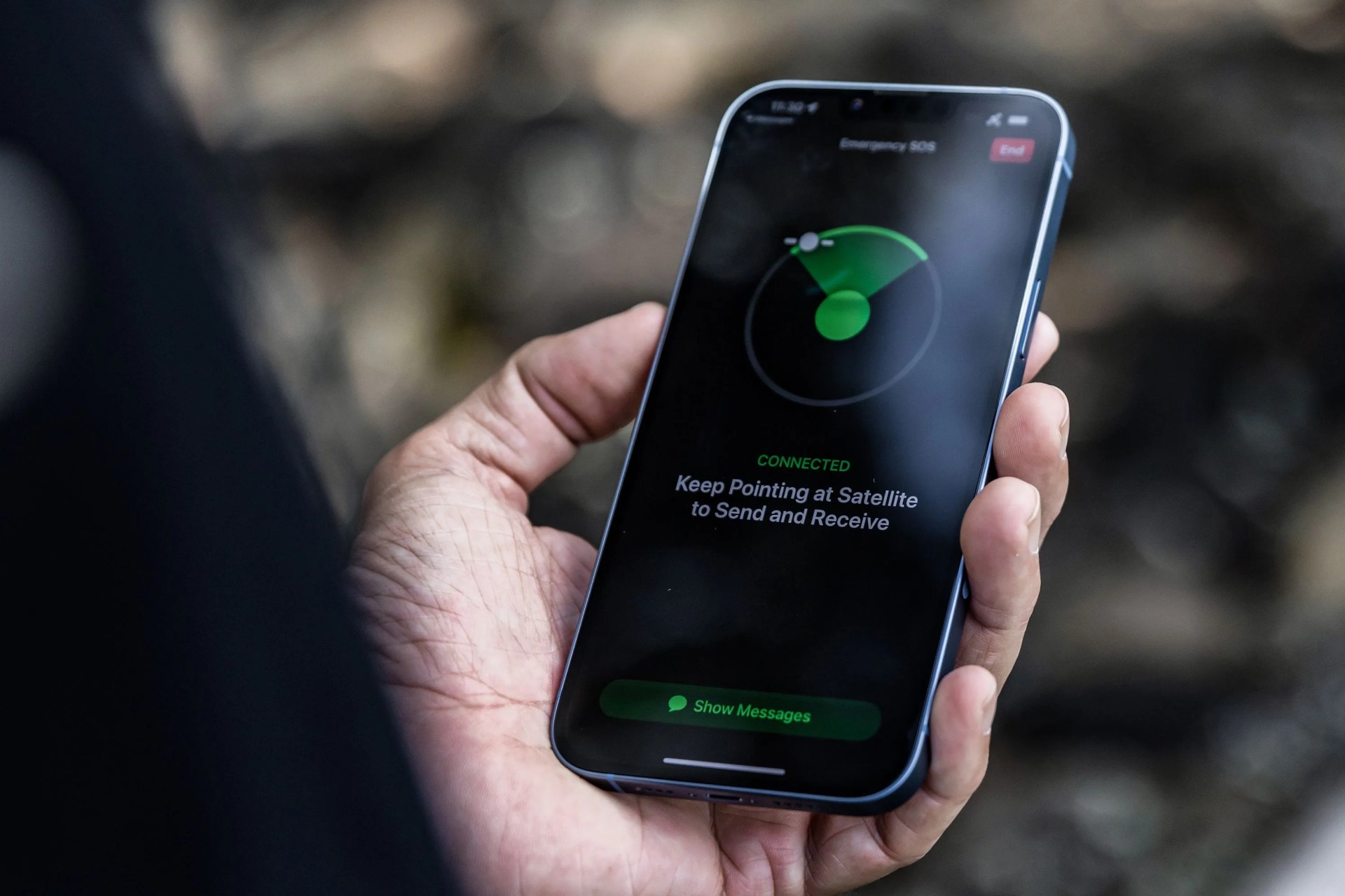 a person holding an iphone looking at an sos app