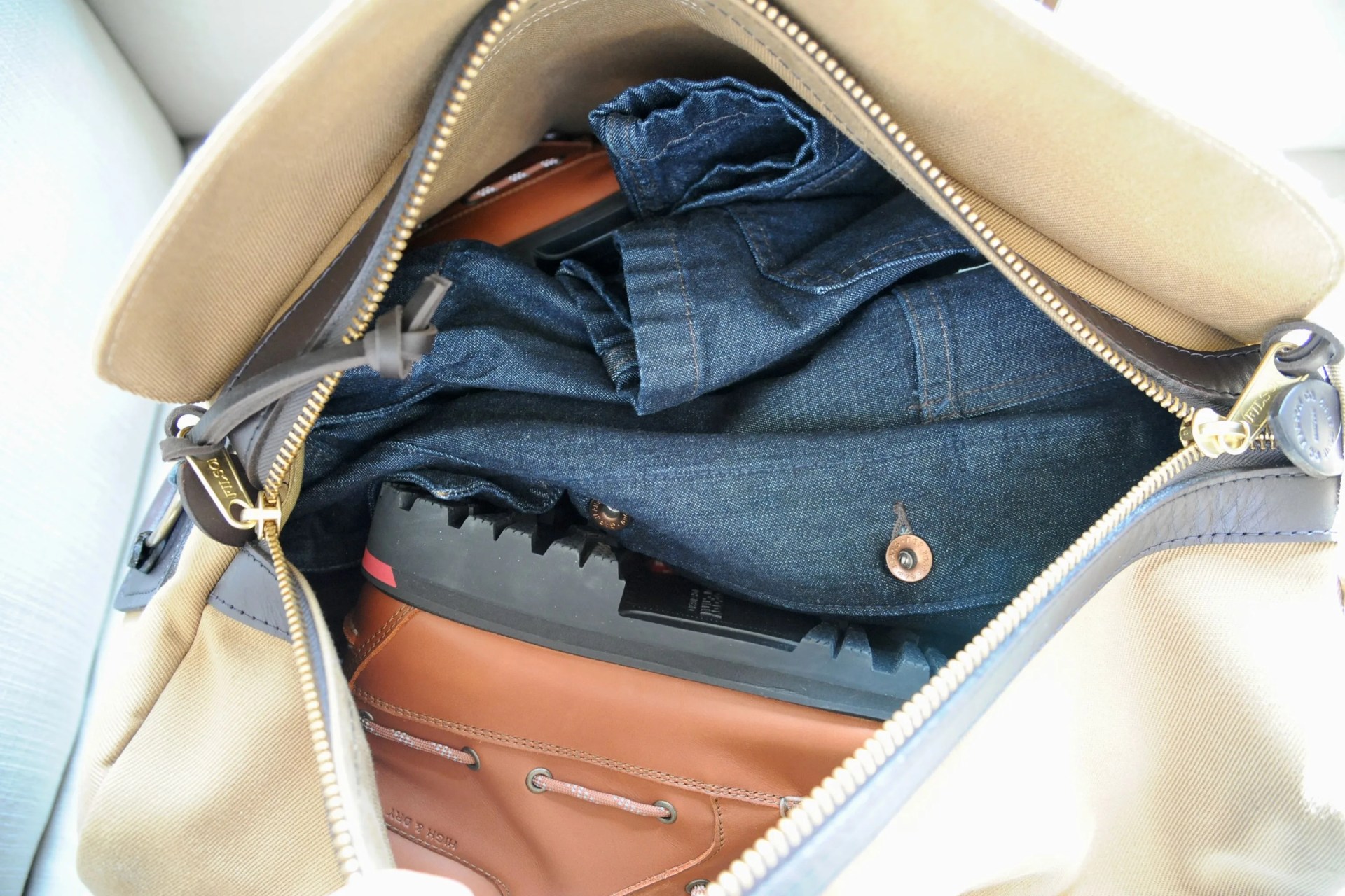 filson duffel bag open with clothes packed inside