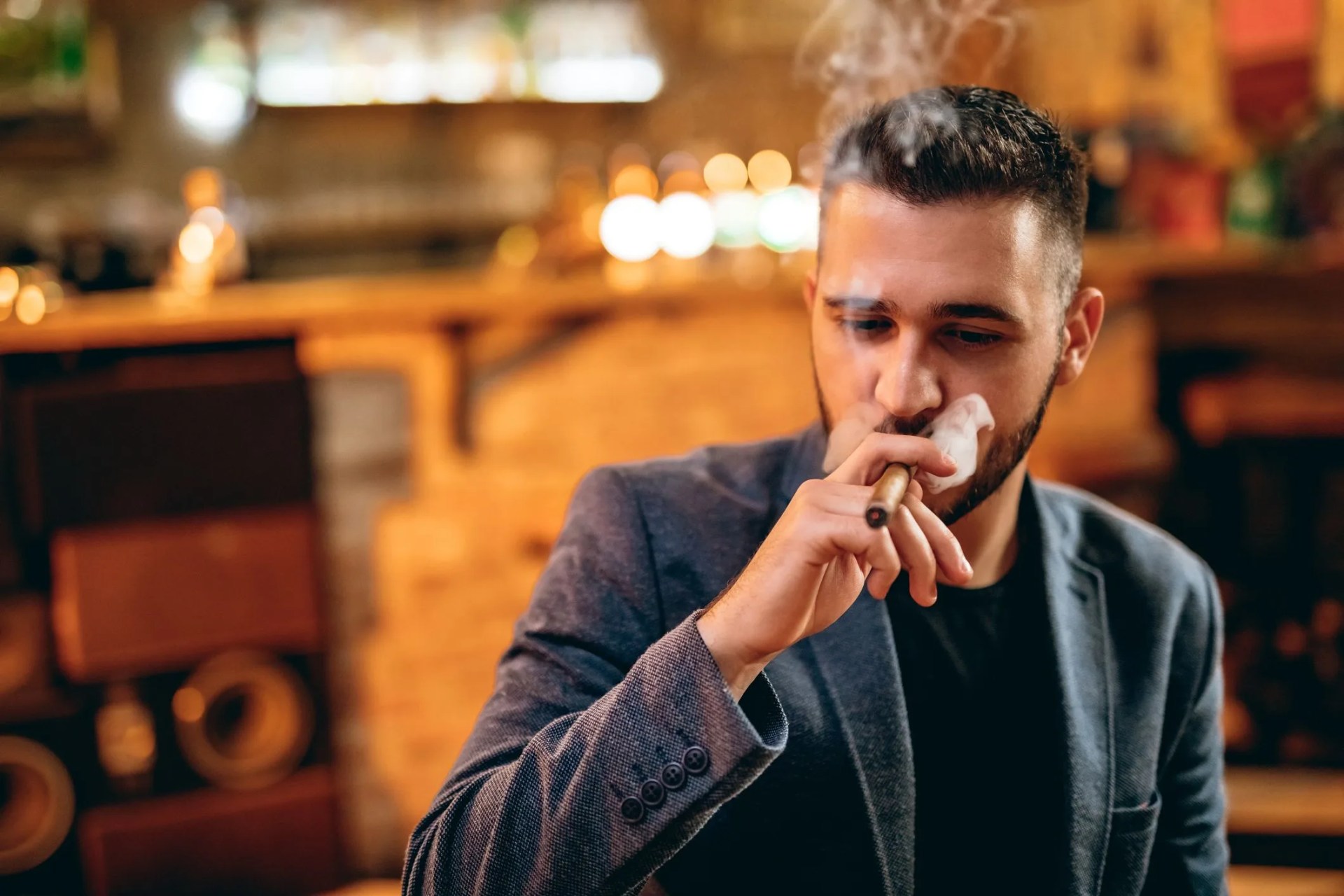 handsome bearded man smoking cigar