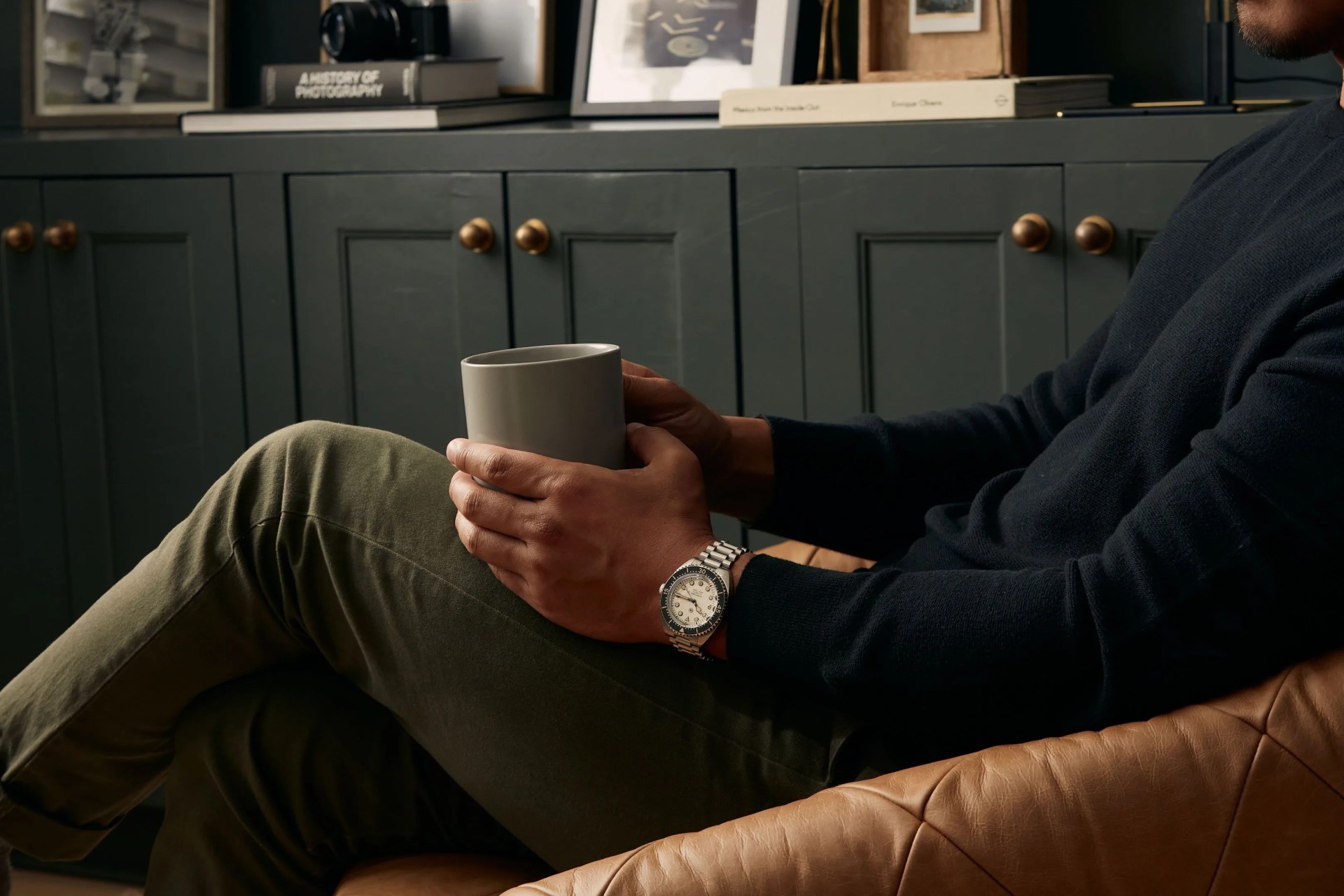 man sitting down wearing jack mason hydro timer watch