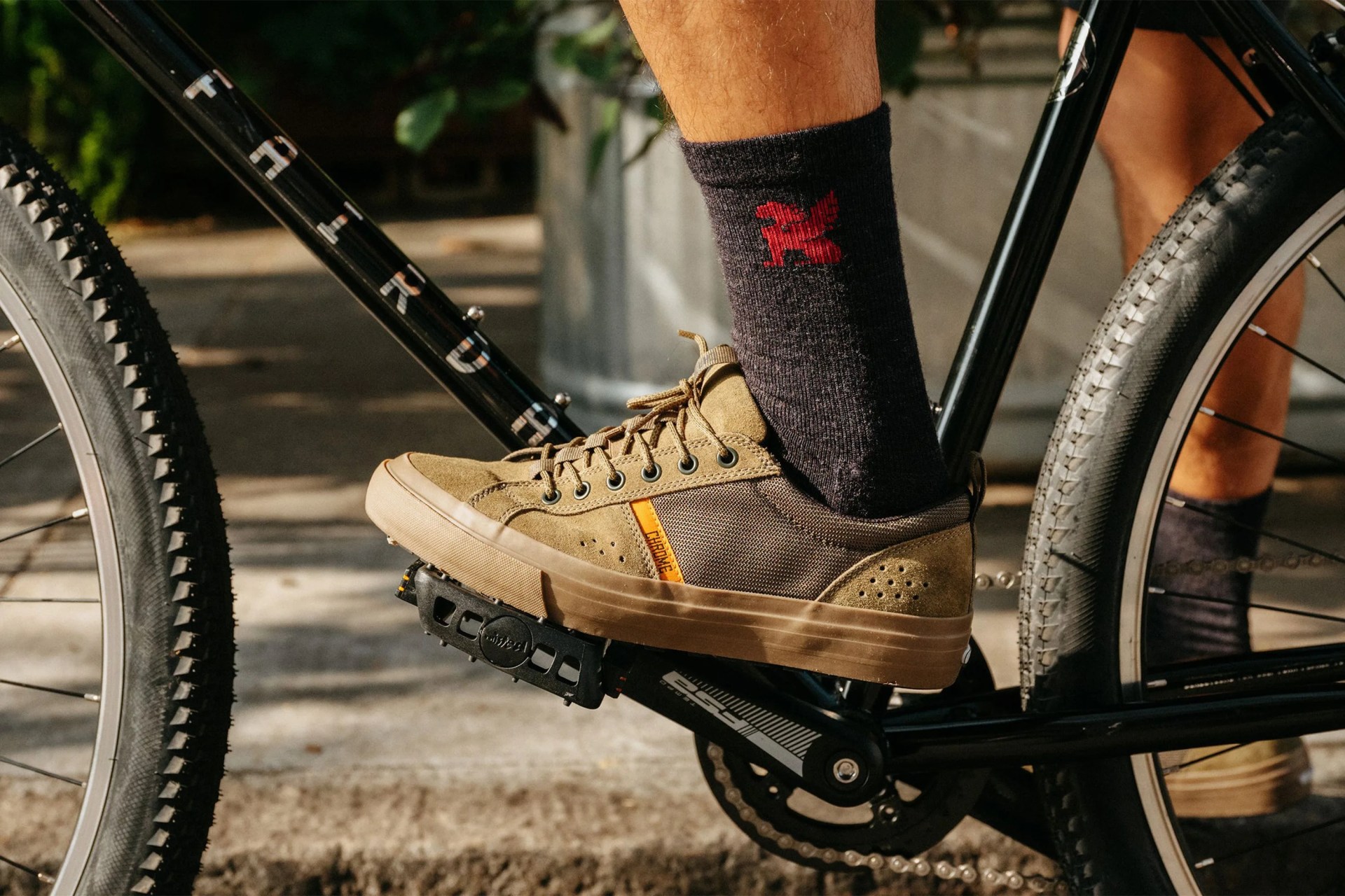 close up of a person wearing sneakers on a bike pedal