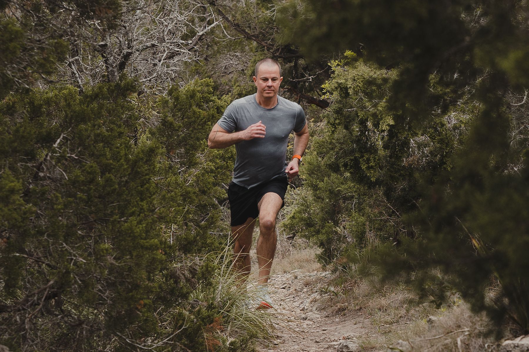 man running through forest
