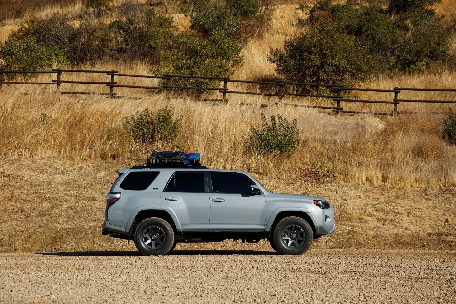 toyota 4runner parked next to a mountain ranch fence