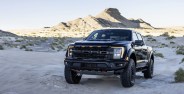 ford f 150 raptor r parked in the sand