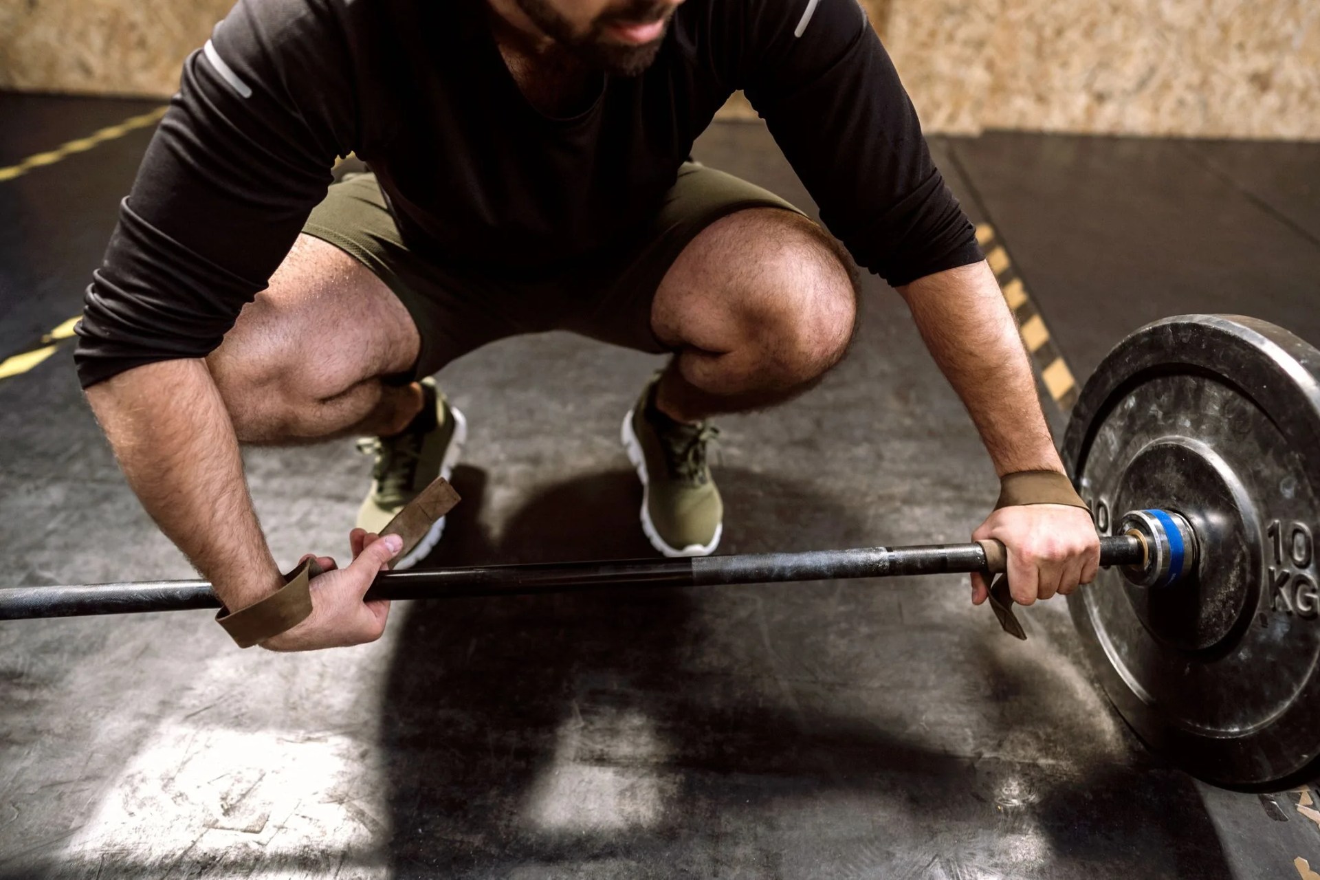 close up of young weightlifter preparing for dead lifting