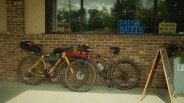 two bikes leaning up against a wall