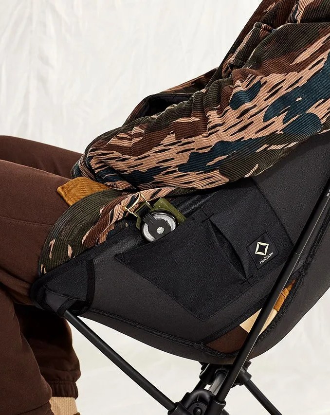 man sitting on helinox tactical gear chair