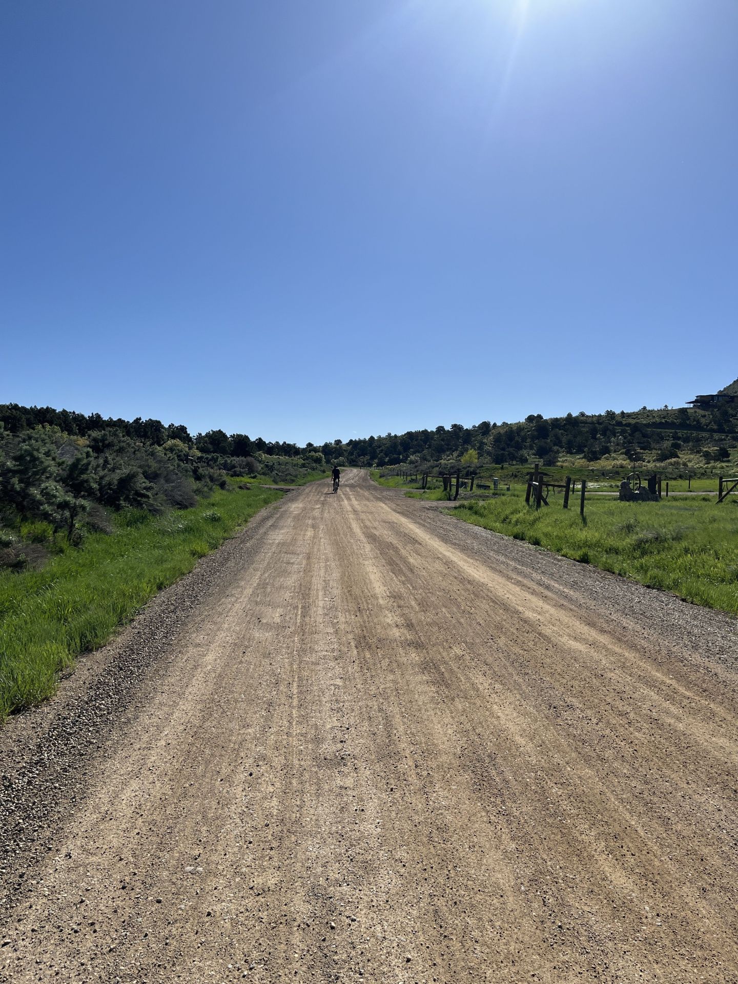 gravel road with cyclist in the distance