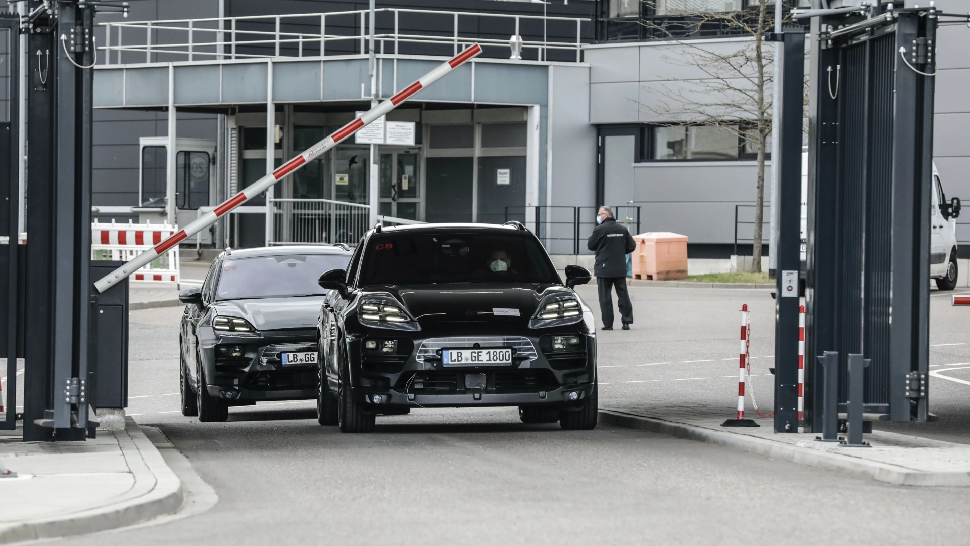 porsche electric macan exiting a porsche facility