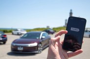 turo app open on phone in front of car and lighthouse