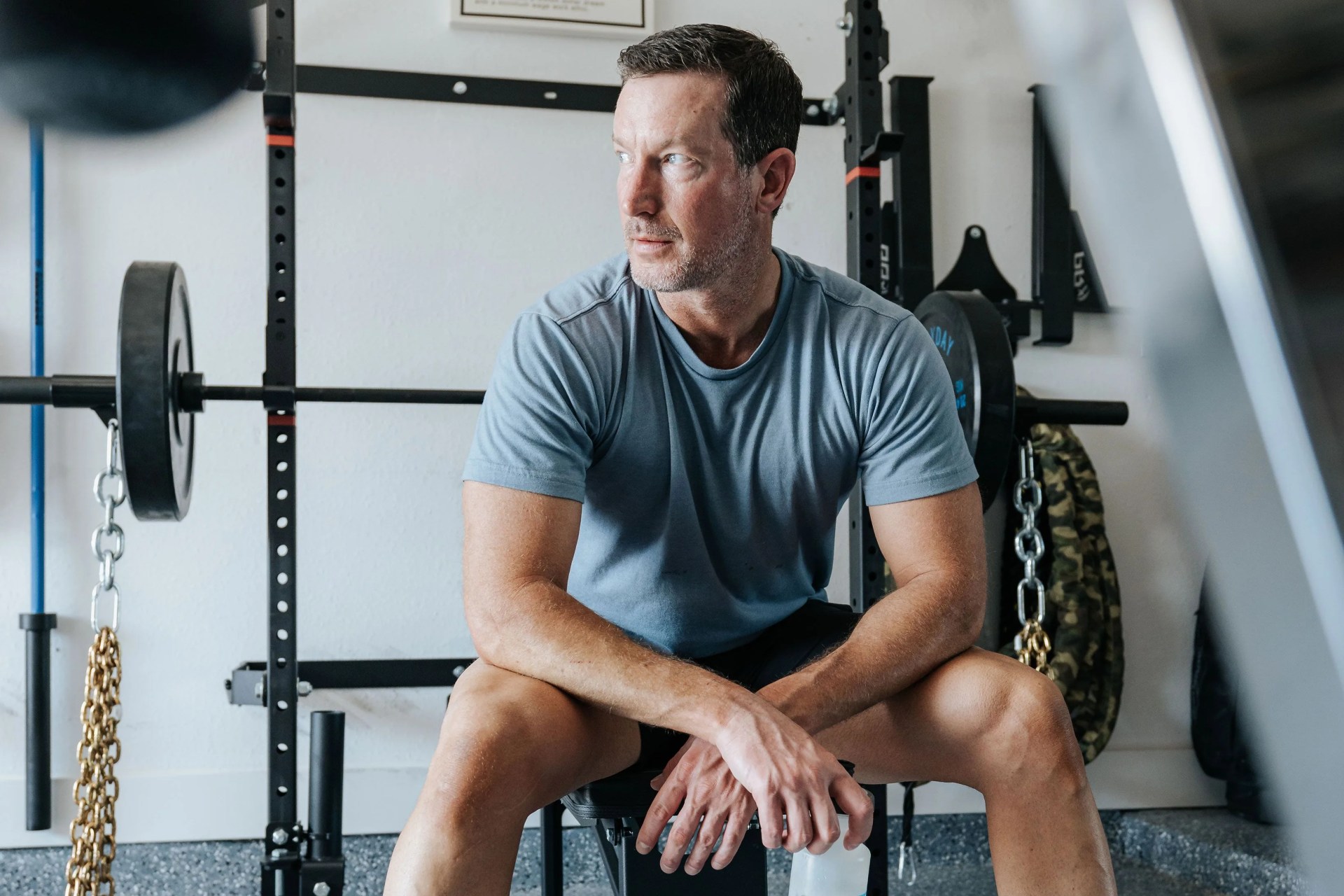 man sitting on workout equipment