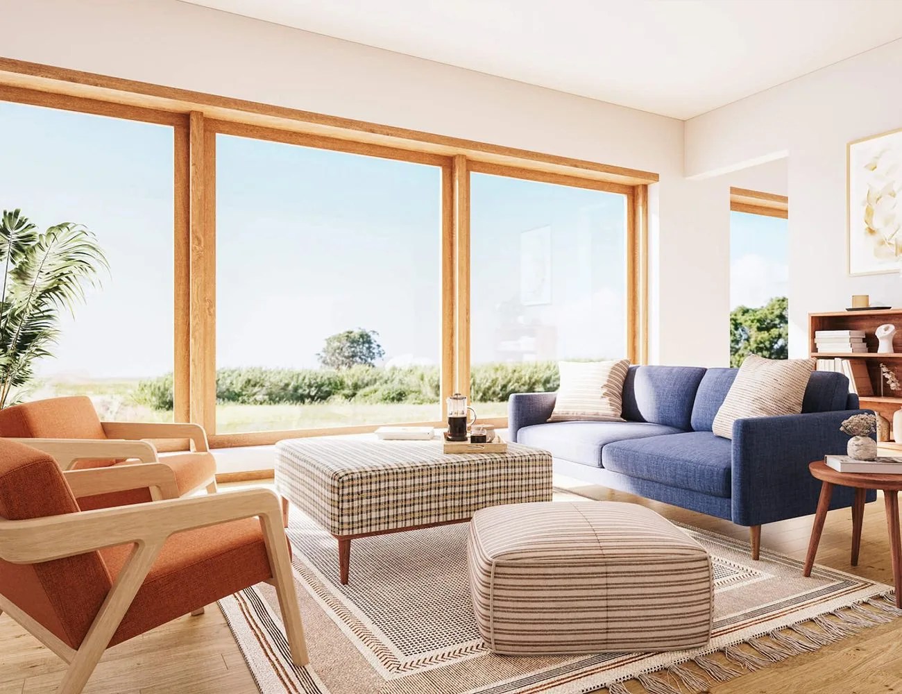 two chairs, ottomans, and a couch in a room with floor to ceiling windows