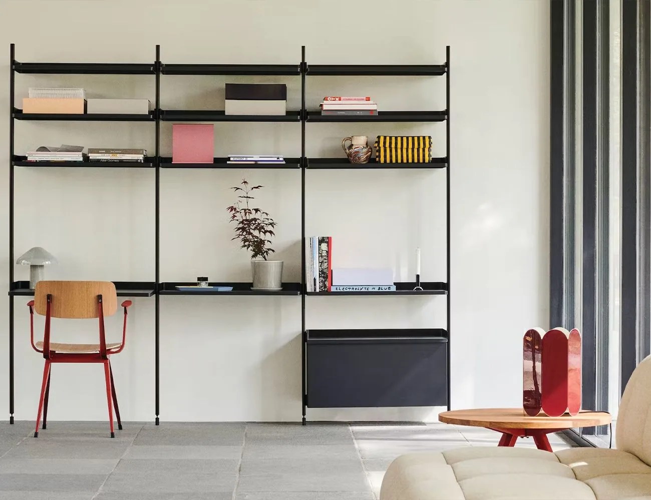 a chair at a shelf desk in a living room with a couch