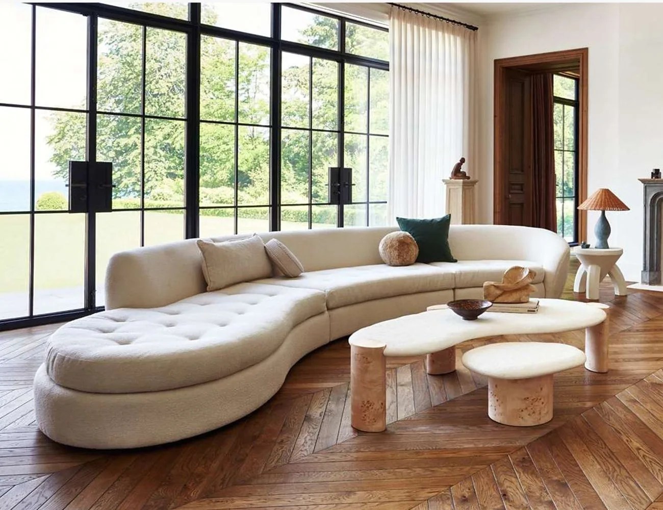 a couch next to floor to ceiling window doors
