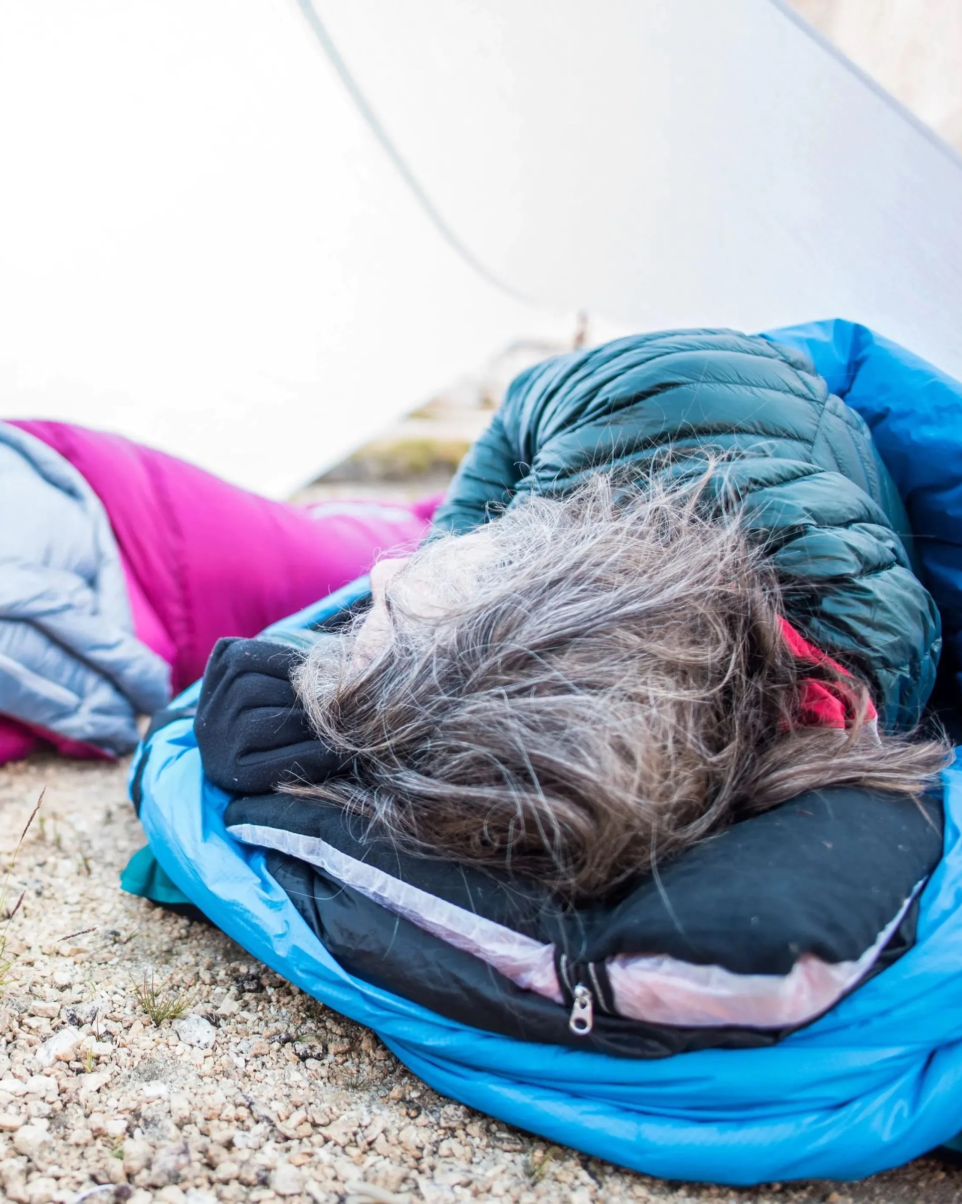 woman sleeping on hyperlite mountain gear stuff sack pillow in white dyneema