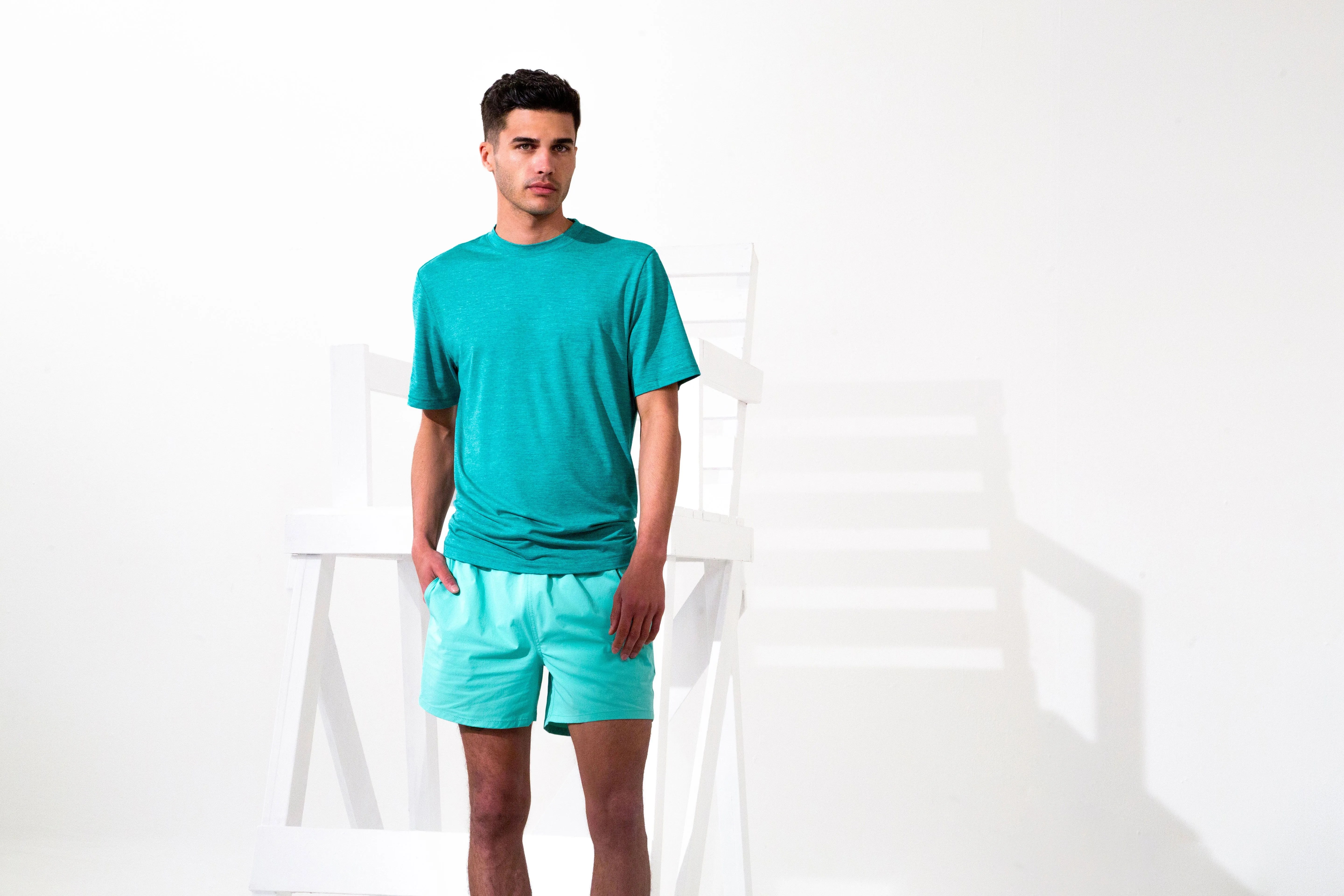 man wearing bugatchi teal shirt and shorts