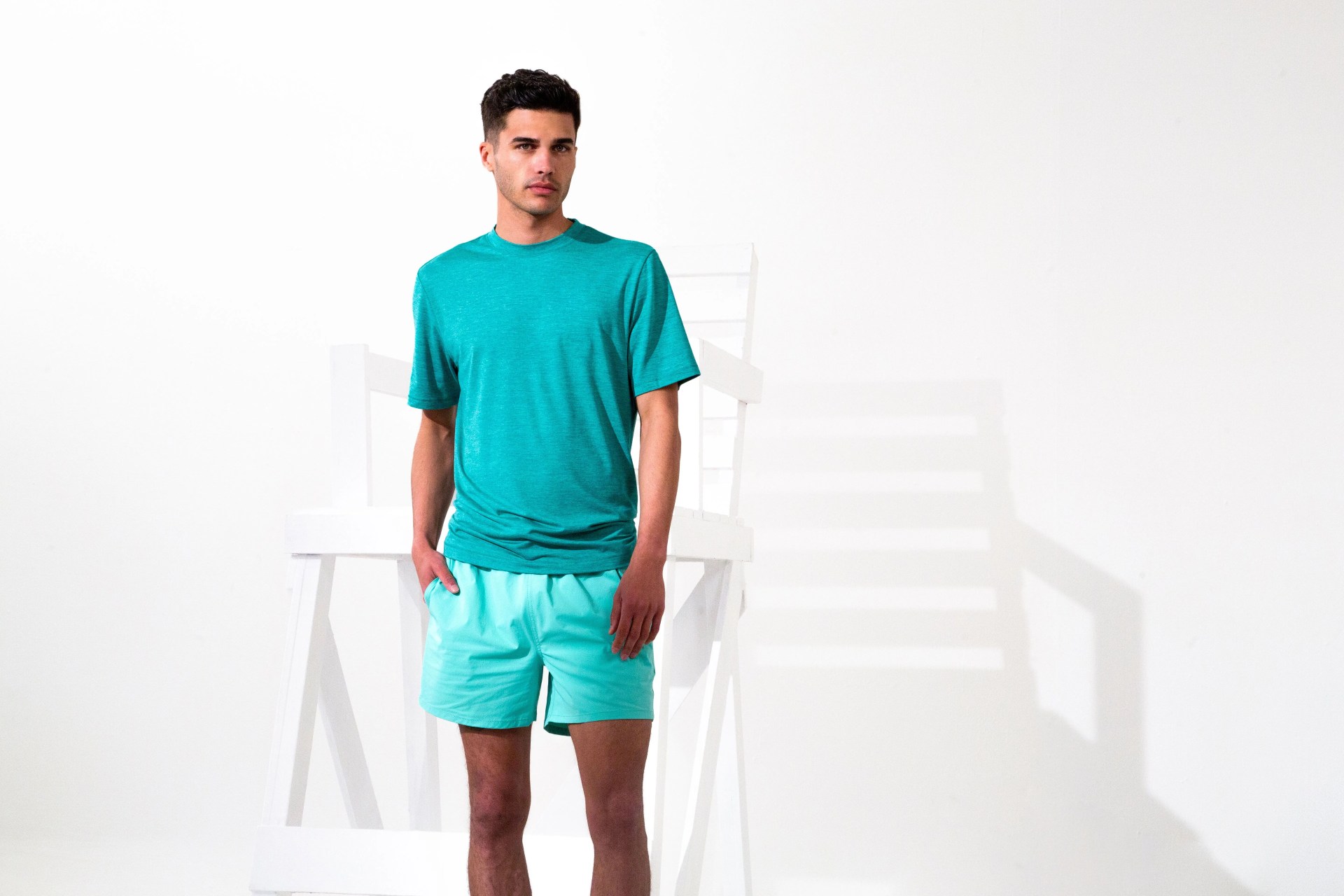 man wearing bugatchi teal shirt and shorts