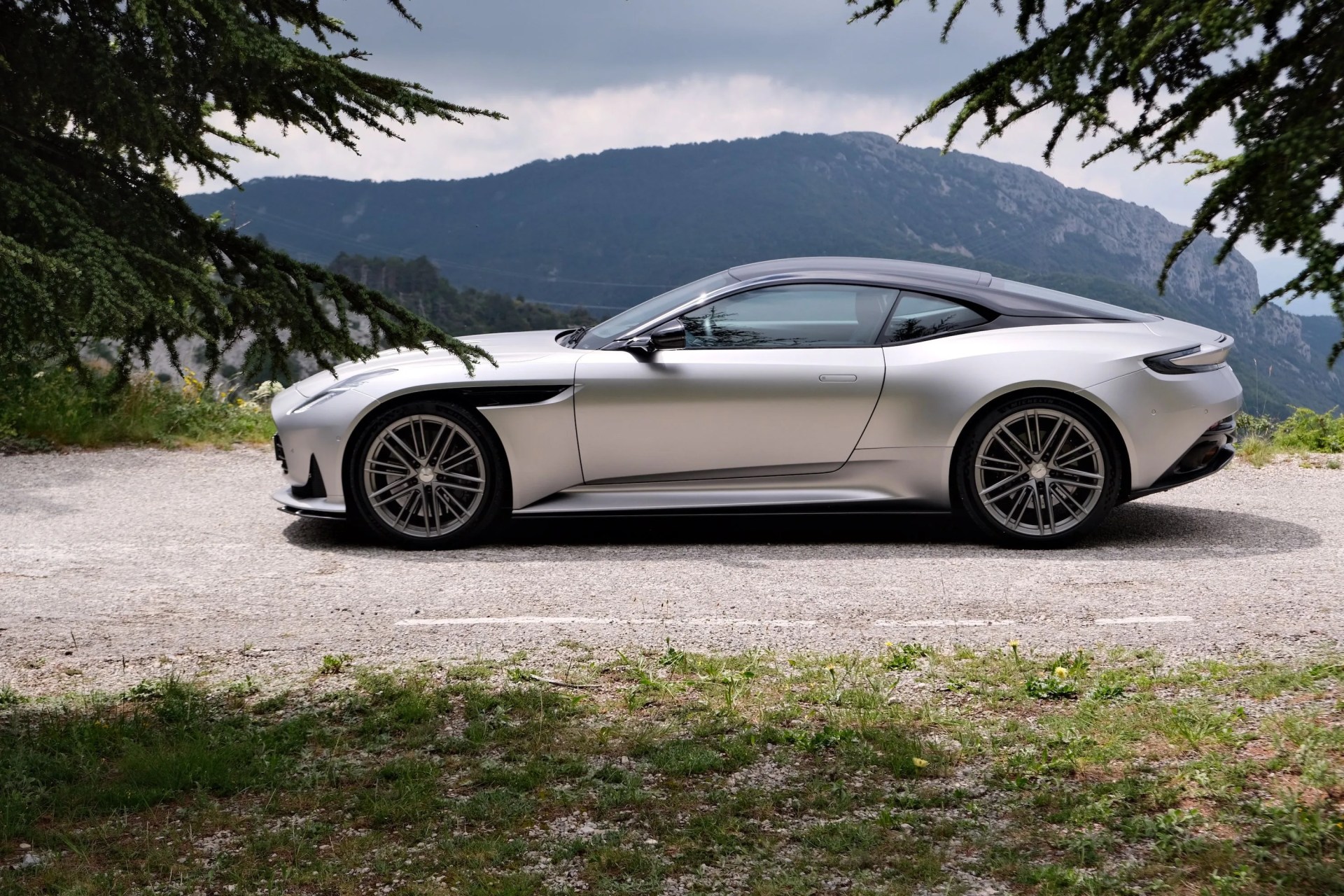 aston martin parked by a mountain