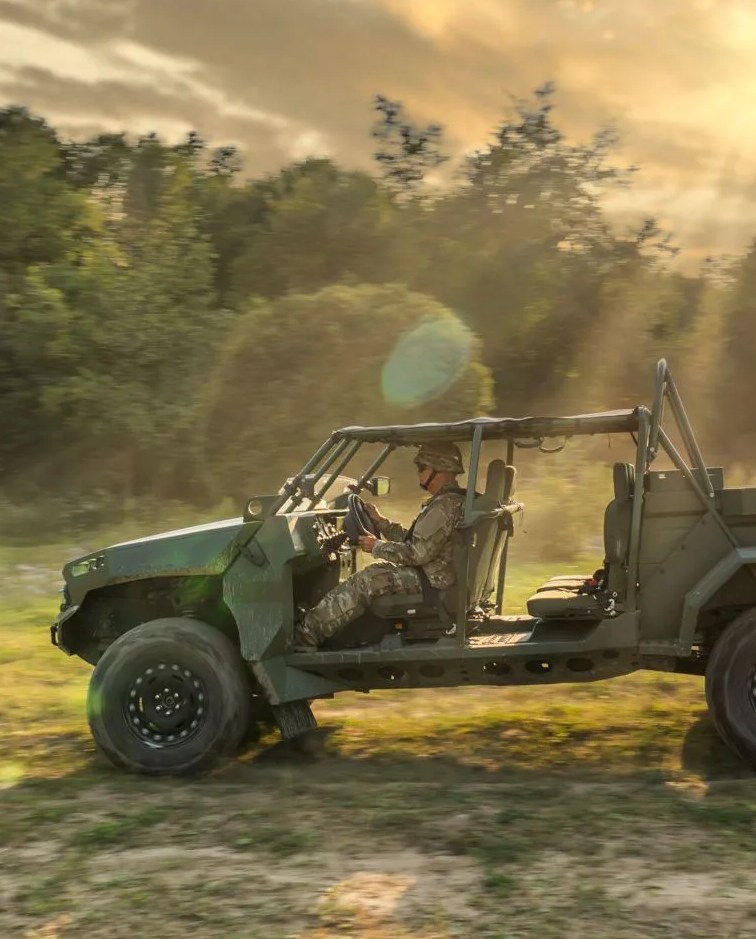 man driving gm defense llc all electric military concept vehicle