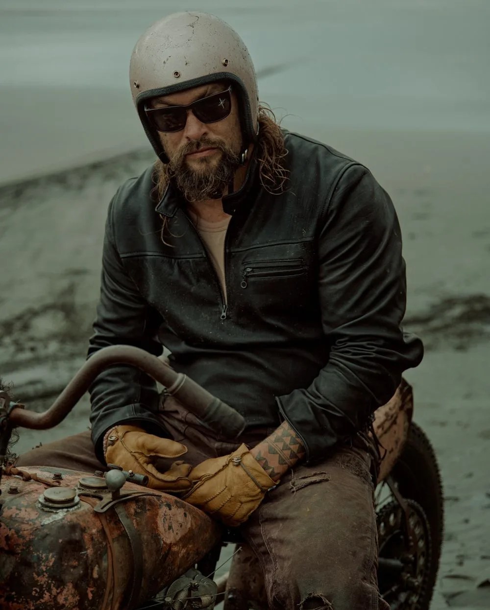 jason momoa sitting on motorcycle wearing on the road harley davidson gear