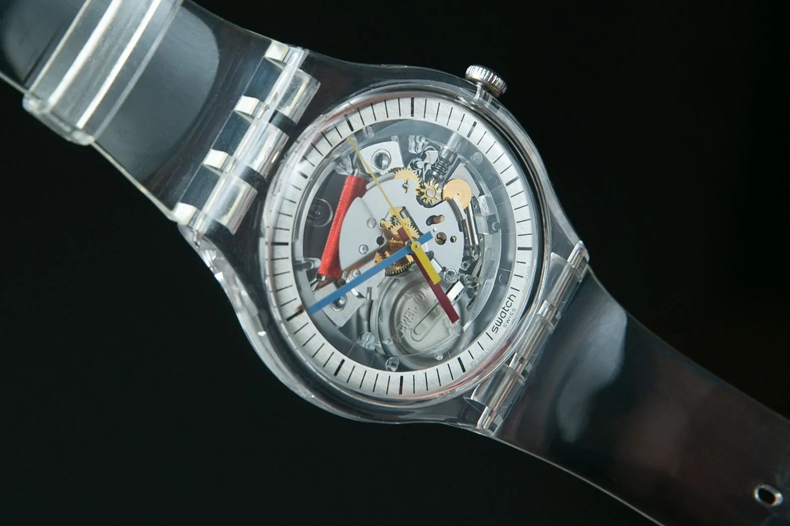 clear plastic watch against black backgound