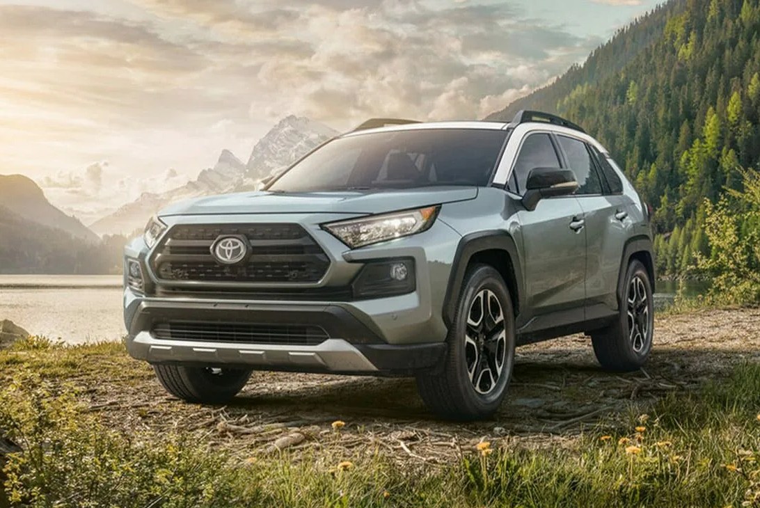 toyota rav4 parked by a river in the mountains